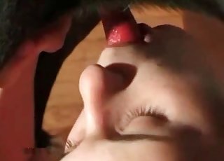 She happily sucks on dog's cock