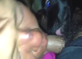 Colorfully dressed lady sucks off a black dog